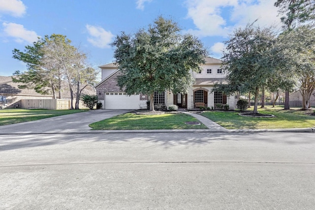 view of property hidden behind natural elements with a garage and a front yard