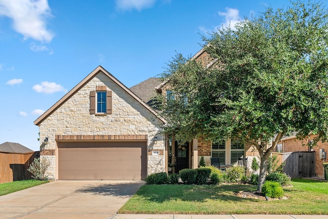 view of front of property with a garage and a front lawn