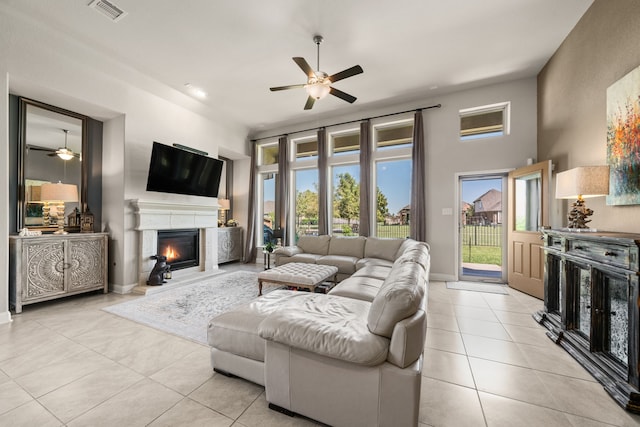 living room featuring light tile patterned floors and ceiling fan