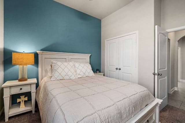 bedroom featuring dark colored carpet and a closet