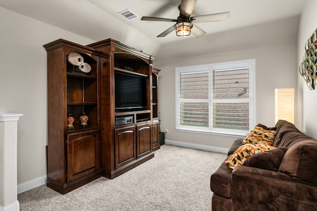 living room with light carpet, vaulted ceiling, and ceiling fan