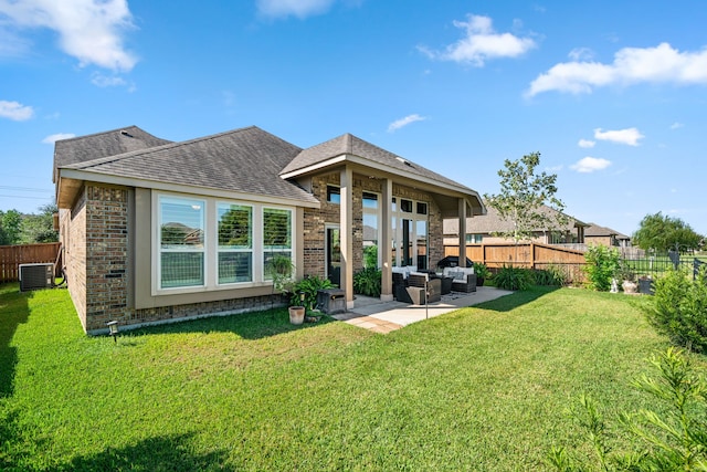 rear view of property featuring an outdoor living space, central AC, a lawn, and a patio area