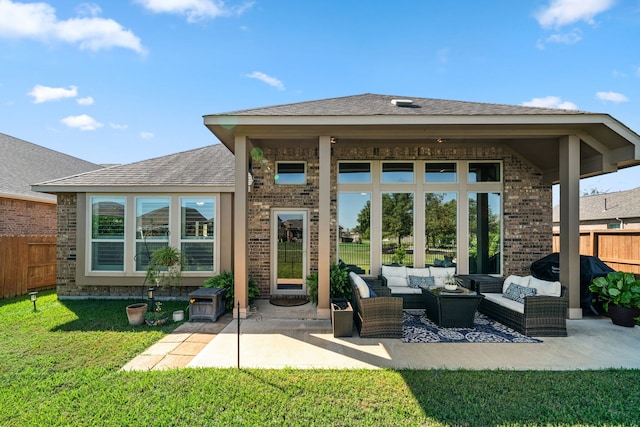 back of property with an outdoor hangout area, a patio area, and a lawn