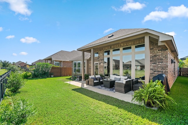 rear view of house with an outdoor hangout area, a patio area, and a lawn