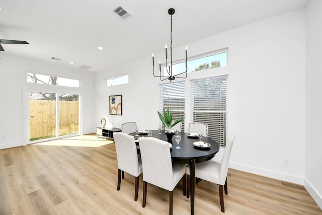 dining room featuring a notable chandelier and light wood-type flooring