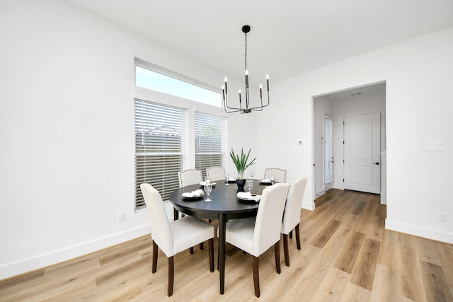 dining room with a chandelier and light hardwood / wood-style flooring