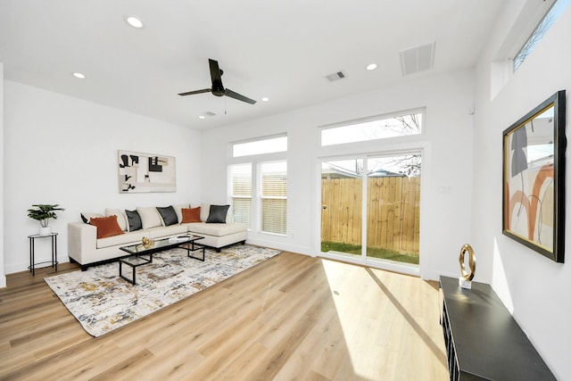 living room with hardwood / wood-style floors and ceiling fan