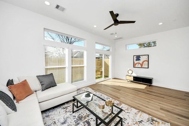 living room featuring hardwood / wood-style flooring and ceiling fan