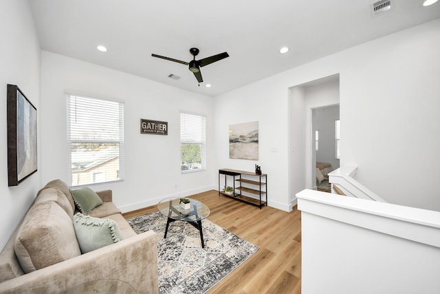 living room with hardwood / wood-style flooring and ceiling fan