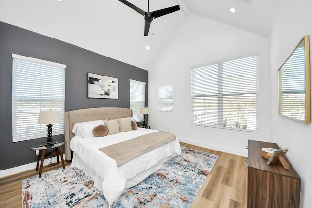 bedroom with light hardwood / wood-style flooring, ceiling fan, and vaulted ceiling