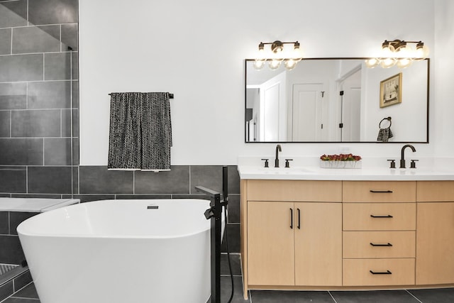 bathroom with vanity, a tub, tile walls, and tile patterned floors