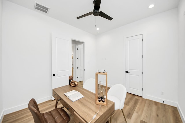 office with light hardwood / wood-style floors and ceiling fan