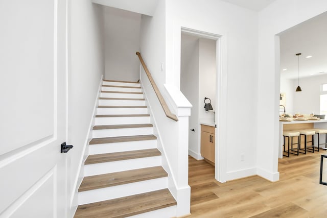 staircase with wood-type flooring