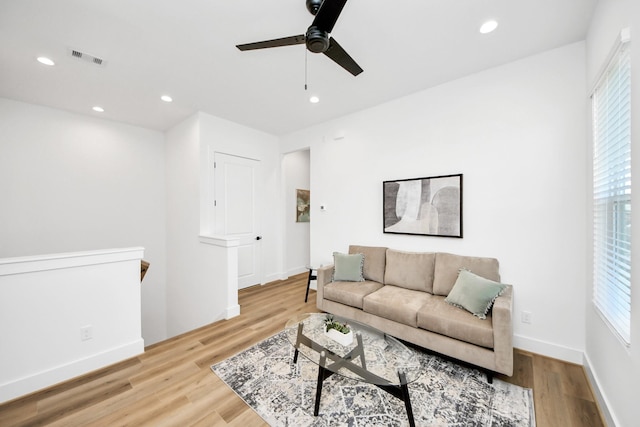 living room with ceiling fan and light wood-type flooring