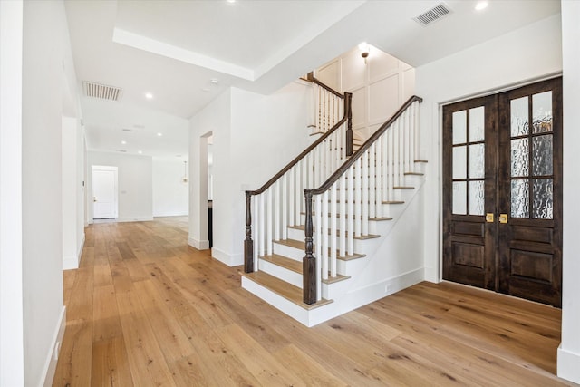 entryway with light wood-type flooring and french doors