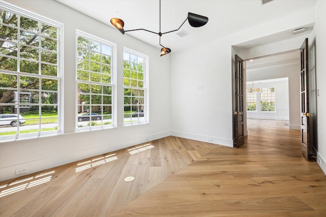 unfurnished dining area with wood-type flooring