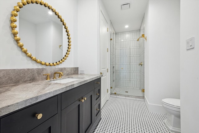 bathroom featuring vanity, toilet, and walk in shower