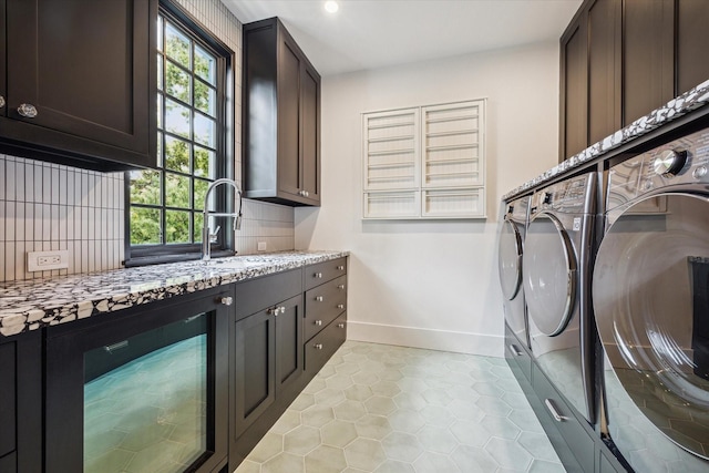 laundry room with wine cooler, cabinets, plenty of natural light, and separate washer and dryer