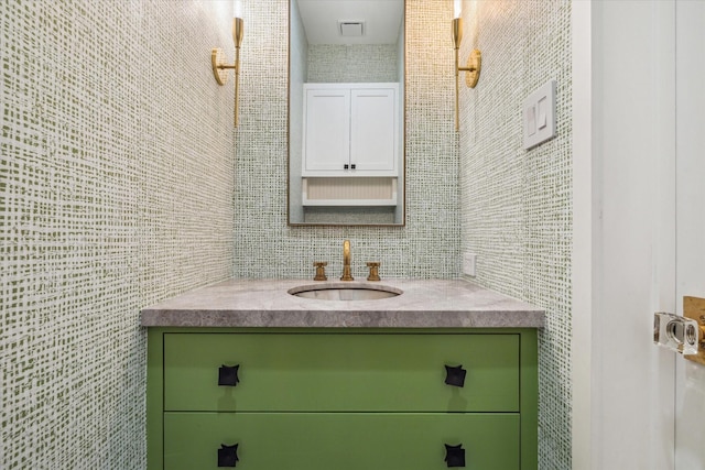 bathroom with vanity and tile walls