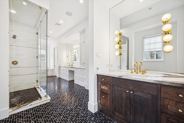 bathroom with vanity and a shower with shower door