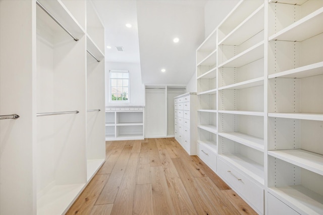 walk in closet featuring light hardwood / wood-style flooring