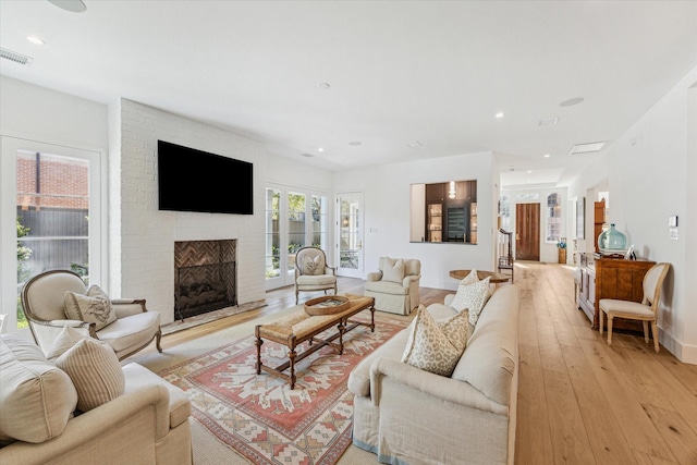 living room featuring a fireplace and light hardwood / wood-style flooring