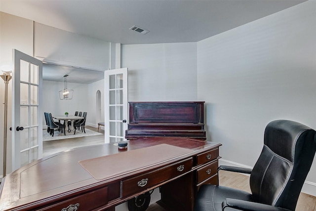 office space with light hardwood / wood-style flooring and french doors