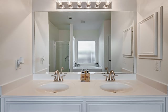 bathroom featuring independent shower and bath and vanity