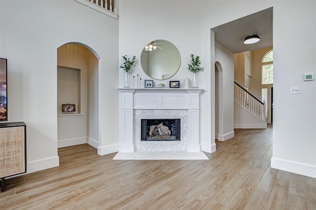 unfurnished living room with a fireplace and light wood-type flooring