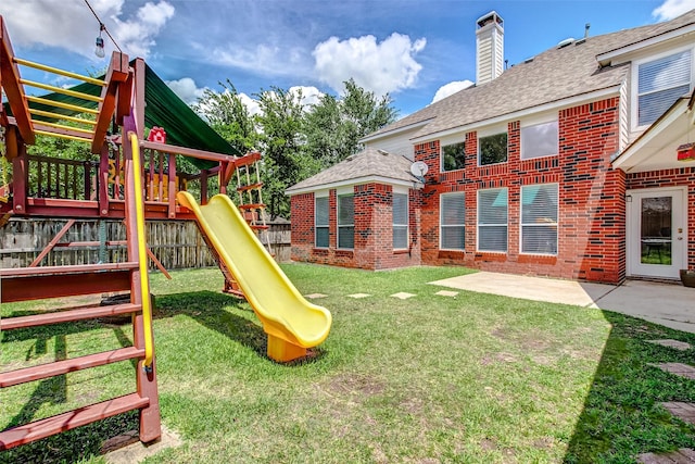 view of play area with a patio and a yard