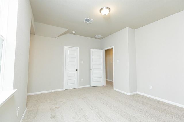 unfurnished bedroom with light colored carpet