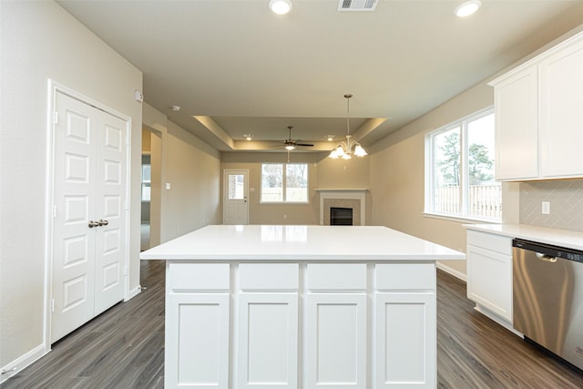 kitchen with stainless steel dishwasher, a center island, and white cabinets