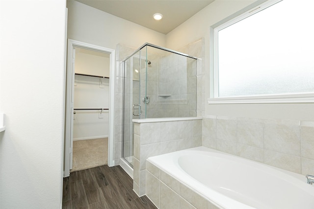 bathroom with wood-type flooring and separate shower and tub