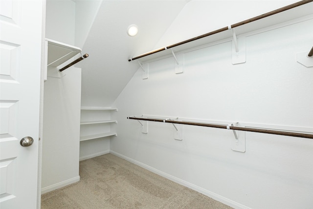 spacious closet with light carpet and lofted ceiling