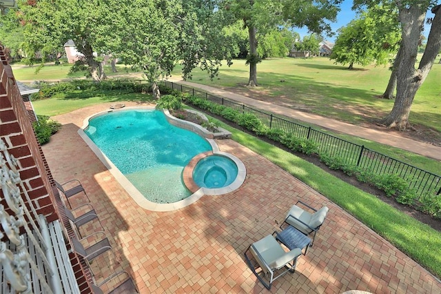 view of swimming pool with a yard, a patio area, and an in ground hot tub