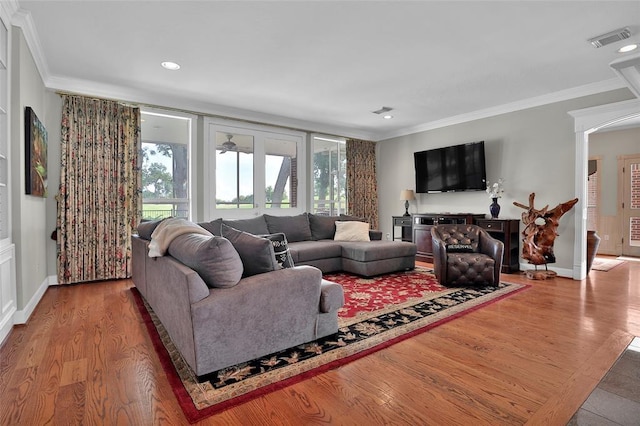 living room featuring wood-type flooring and ornamental molding