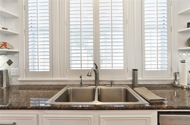 kitchen featuring sink, plenty of natural light, dishwasher, decorative backsplash, and white cabinets