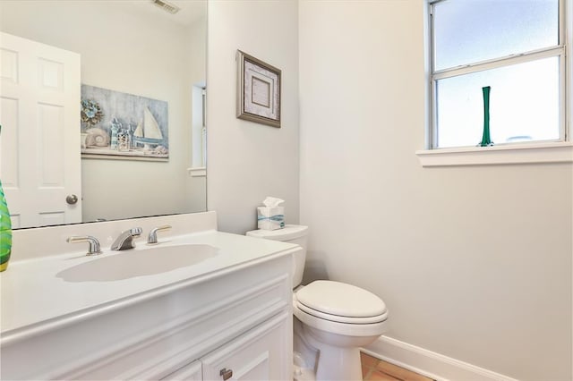 bathroom featuring vanity, tile patterned floors, and toilet