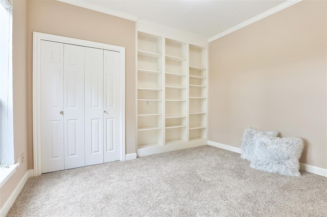 unfurnished bedroom featuring crown molding, carpet, and a closet