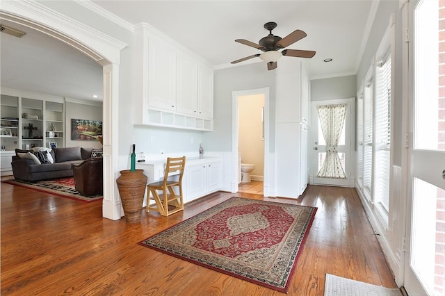 interior space with crown molding, ceiling fan, and hardwood / wood-style flooring