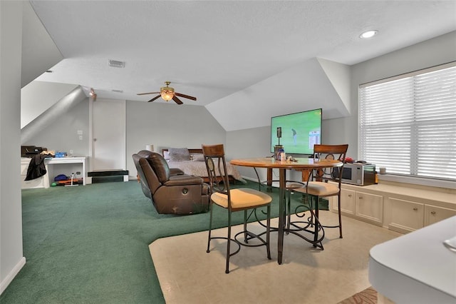 interior space featuring lofted ceiling, light colored carpet, and ceiling fan