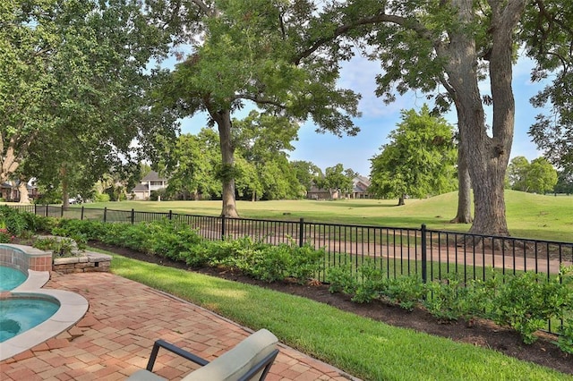 view of community with a patio and a lawn