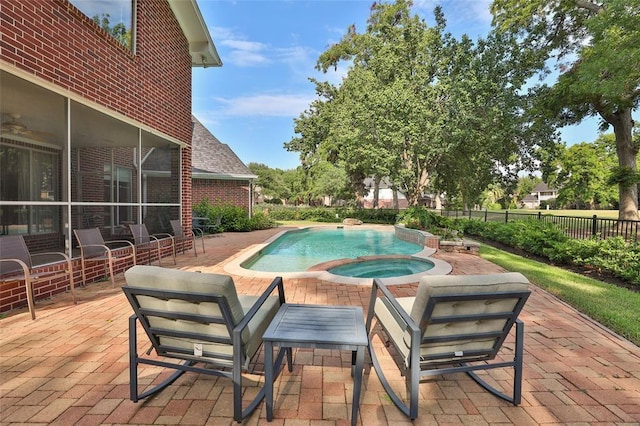 view of pool featuring an in ground hot tub and a patio