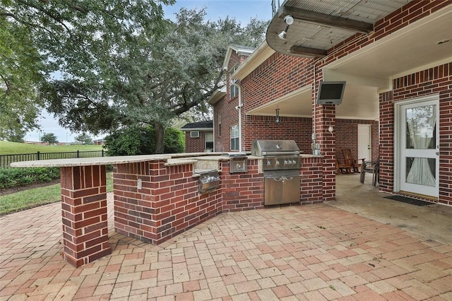 view of patio featuring a grill and exterior kitchen