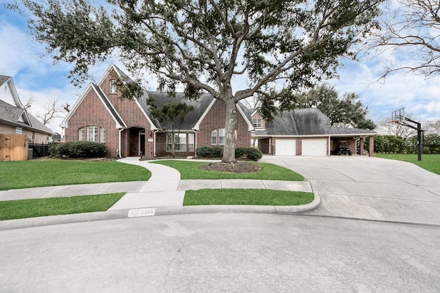 view of front of property featuring a garage, driveway, a front lawn, and brick siding