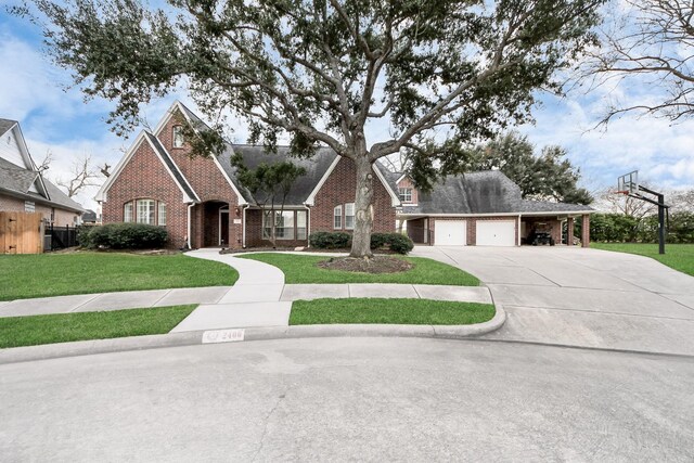 traditional-style home with a garage, concrete driveway, fence, a front lawn, and brick siding