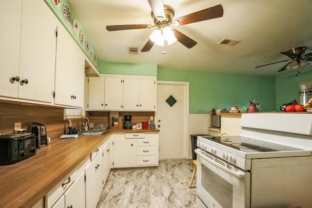 kitchen featuring white cabinetry, white range with electric cooktop, ceiling fan, and sink