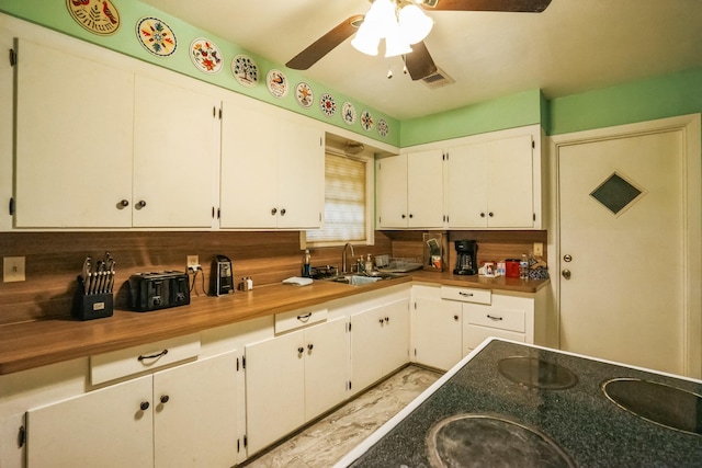 kitchen with sink, white cabinets, and decorative backsplash