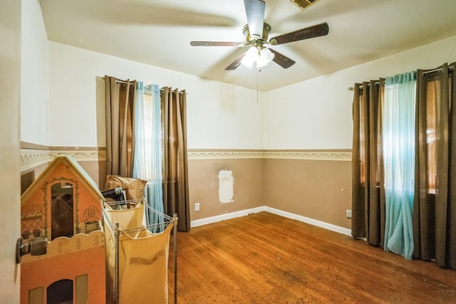 empty room featuring wood-type flooring and ceiling fan