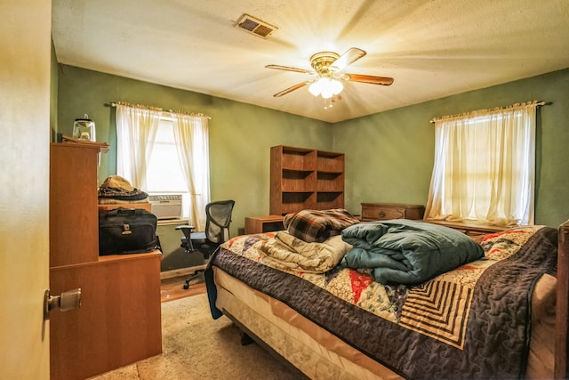 bedroom featuring cooling unit and ceiling fan